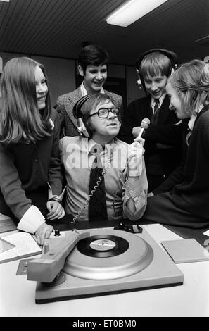 Ed Doolan BRMB Radio Disc Jockey, pictured with news boys and girls, Birmingham, 14th January 1975. Stock Photo