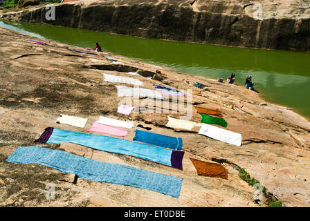 manual open air laundry , drying clothes on rock , Kunnandarkoil ; Kundrandarkoil  ; Pudukkottai ; Tamil Nadu ; India , asia Stock Photo