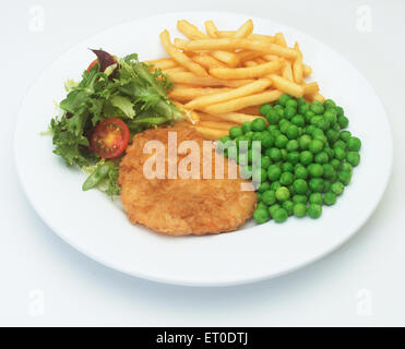 Chicken, peas, chips and salad. Stock Photo