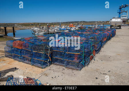 Fishermens lobster pots lined up on the quayside waiting to go on board a fishing boat, Stock Photo