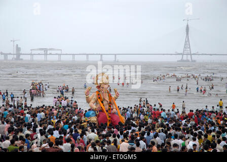 People taking huge lord ganesha idol for immersion at Chowpaty ; Dadar ; Bombay Mumbai ; Maharashtra ; India 2008 Stock Photo