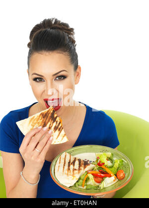 Positive Happy Confident Young Hispanic Woman Eating Mexican Style Quesadula or Quesadilla With A Mixed Salad Isolated Against A White Background Stock Photo