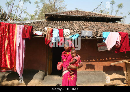 Indian rural woman carrying baby on village road, Ranchi, Jharkhand, India, Indian life Stock Photo