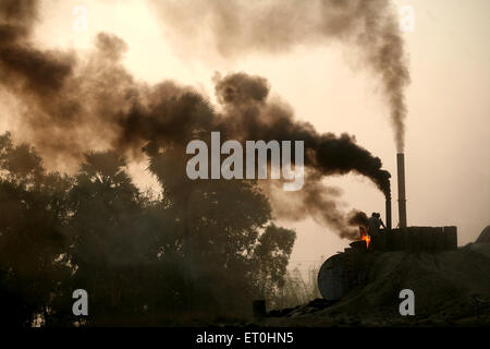 Smoke coming out of tar factory chimney in Jharkhand, India, Asia Stock Photo