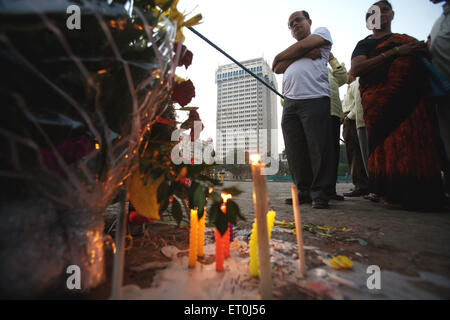 People lighting candles at Gateway paying homage victims terrorist attack Deccan Mujahedeen on 26th November 2008 in Bombay Stock Photo