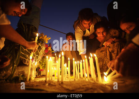 People lighting candles at Gateway paying homage to victims of terrorist attack 26th November 2008 in Bombay Mumbai India Stock Photo