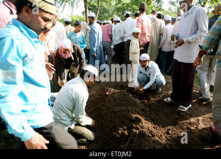 People burying their family members who died in powerful bomb blast on 29th September 2008 at Malegaon ; Maharashtra Stock Photo