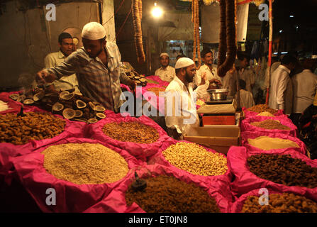 A dry fruit merchant shop at the local market of Malegaon ; Maharashtra ; India Stock Photo