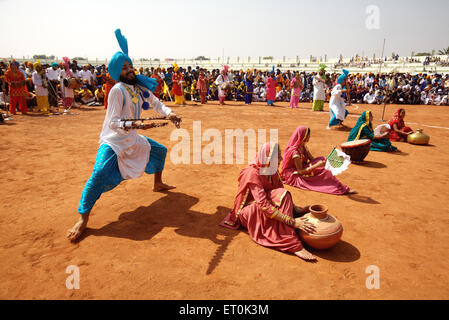 Young Sikh boys girls performing Bhangra folk dance celebrations 300th year consecration perpetual Guru Granth Sahib ; Nanded Stock Photo