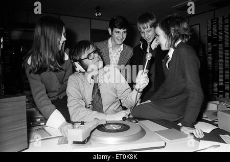 Ed Doolan BRMB Radio Disc Jockey, pictured with news boys and girls, Birmingham, 14th January 1975. Stock Photo