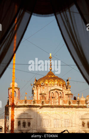 Gumath or tomb of Sachkhand Saheb Gurudwara decorated flowers Consecration of perpetual Sikh Guru Granth ;  Nanded Stock Photo