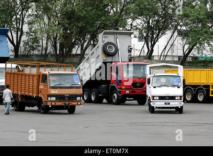 Various commercial products like matadors ; trucks parked at Tata motors plant ; Pimpri near Pune ; Maharashtra ; India Stock Photo