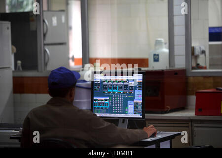 Worker checking standard of milk received at Amul factory in Anand ; Gujarat India Indian quality control Stock Photo