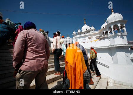Devotees climbing stairs of Gurudwara of Anandpur Sahib during Hola Mohalla  festival in Rupnagar district ; Punjab ; India Stock Photo