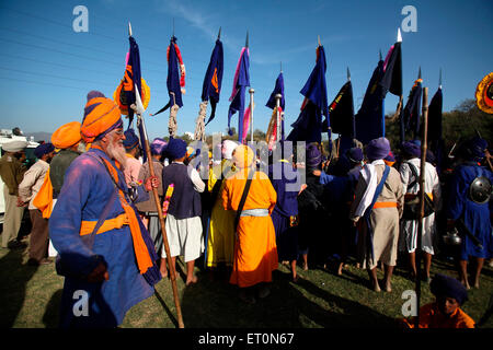 Nihangs or Sikh warriors with flags during Hola Mohalla celebration at Anandpur sahib in Rupnagar Stock Photo