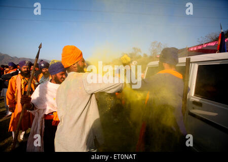 Nihangs or Sikh warriors throwing colours on each other during Holi festival with celebration of Hola Mohalla at Anandpur sahib Stock Photo