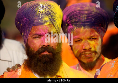 Nihangs or Sikh warriors immersed in yellow color during Holi festival with celebration of Hola Mohalla at Anandpur sahib Stock Photo