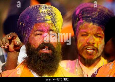 Nihangs or Sikh warriors immersed in yellow color during Holi festival with celebration of Hola Mohalla at Anandpur sahib Stock Photo
