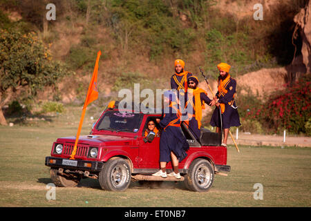 Nihangs or Sikh warriors driving in Maruti Suzuki during the Hola Mohalla celebration at Anandpur sahib in Rupnagar Stock Photo