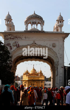 Devotees at entrance gate near Ath sath Tirath to Harmandir Sahib or Darbar Sahib or Golden temple in Amritsar ; Punjab ; India Stock Photo