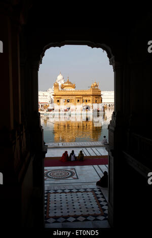 Clock Tower gate to Harmandir Darbar Sahib or Golden Temple surrounded by lake in Amritsar ; Punjab ; India Stock Photo