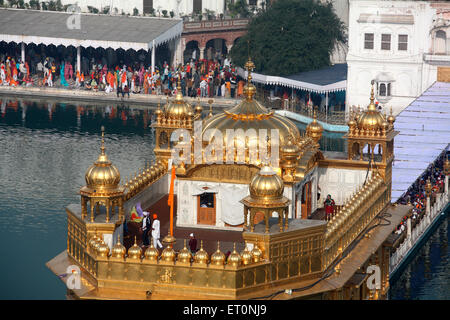 Close view of top of Harmandir Sahib or Darbar Sahib or Golden temple surrounded by lake in Amritsar ; Punjab ; India Stock Photo