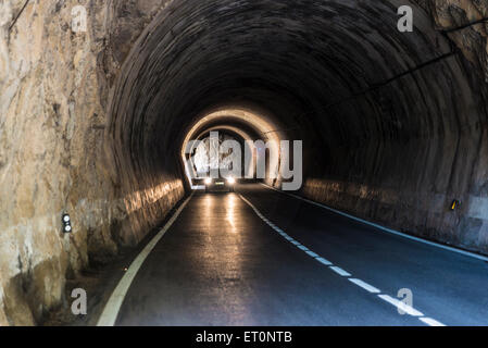Car running through an old tunnel with galleries through which light enters in Spain Stock Photo