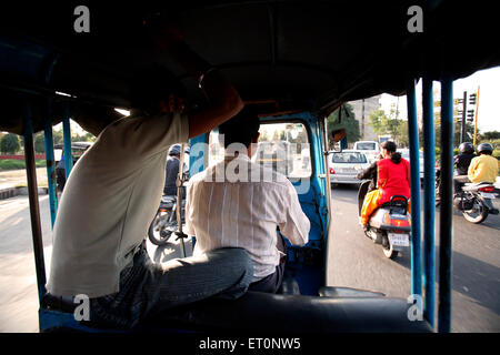 Passenger sitting behind driver in auto rickshaw at Chandigarh Union Territory  ; India Stock Photo