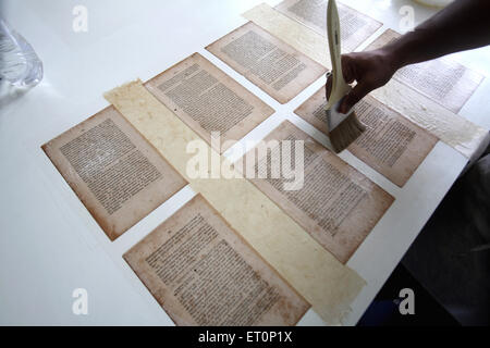 Preservation work of rare books in library of mumbai university ; Bombay Mumbai ; Maharashtra ; India 9 July 2009 Stock Photo