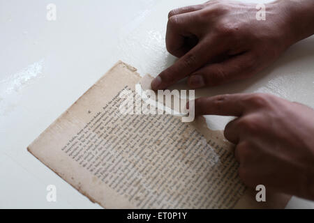 Preservation work of rare books in library of mumbai university ; Bombay Mumbai ; Maharashtra ; India 9 July 2009 Stock Photo