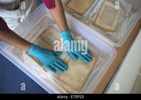 Preservation work of rare books in library of mumbai university ; Bombay Mumbai ; Maharashtra ; India 9 July 2009 Stock Photo