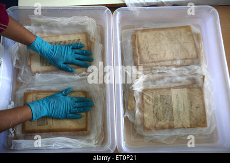 Preservation work of rare books in library of mumbai university ; Bombay Mumbai ; Maharashtra ; India 9 July 2009 Stock Photo