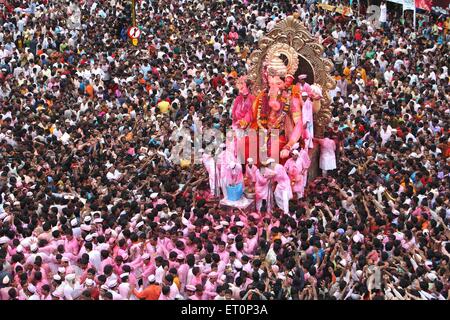 Devotees watching Ganesh festival immersion procession of Lalbaugcha Raja ; largest idol ; Bombay ; Mumbai ; Maharashtra ; India ; Asia Stock Photo