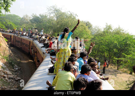 People taking risk while travelling on roof of train ; Goram ghat ; Marwar Junction ; Rajasthan ; India Stock Photo