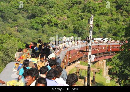 msa 155949 - People taking risk while traveling on roof of train ; Goram ghat ; Marwar Junction ; Rajasthan ; India Stock Photo