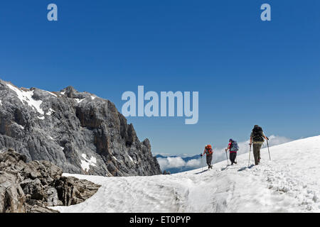 Hikers Heading Towards the Pena Olvidada Mountain in the Picos de Europa Mountains, Cordillera Cantabria Spain Stock Photo