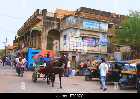 Horse cart with autos motorbike in market ; Fatehpur Shekhavati ; Rajasthan ; India ; Asia Stock Photo