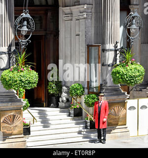 Knightsbridge one doorman in uniform outside the ornate entrance & steps to five star luxury Mandarin Oriental Hotel Hyde Park London England UK Stock Photo