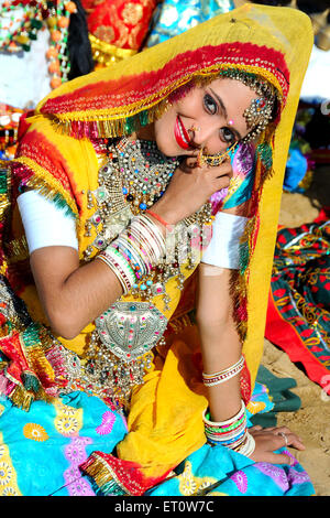 Rajasthani woman giving pose wearing traditional dress in front house ...