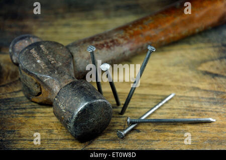 Hammer and nails on wood plank Stock Photo