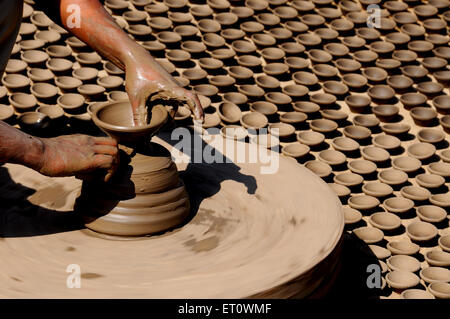 Potter making sand lamps on a potter wheel ; Jodhpur ; Rajasthan ; India Stock Photo