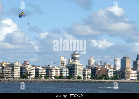 Parasailing ; paragliding by power boats ; Nariman Point ; Marine Drive ; Charni Road ; coast of Arabian sea ; Bombay Mumbai Stock Photo