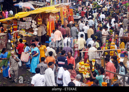 Crowd in flower market purchasing articles decorate idols Lord Ganesh ; celebrating Ganapati festival at Dadar ; Bombay Mumbai Stock Photo