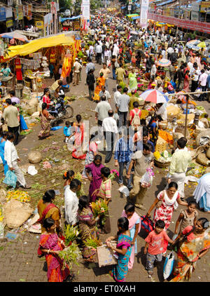 Crowd in flower market purchasing articles decorate idols Lord Ganesh ; celebrating Ganapati festival at Dadar ; Bombay Mumbai Stock Photo
