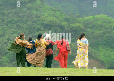 Old women in mist at Malshej Ghat ; Maharashtra ; India Stock Photo