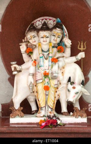 Idol of lord dattatreya datta with cow and dogs in temple ; Ozar ; Junnar ; Pune ; Maharashtra ; India 2010 Stock Photo