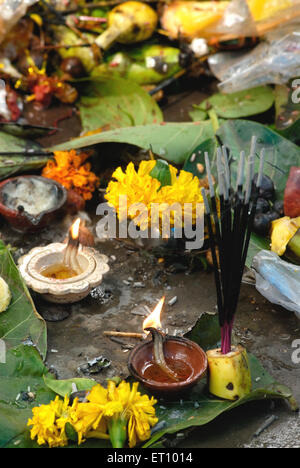 Incense sticks and oil lamps praying tree worship, Vat Savitri festival, Vat Purnima festival, Bombay, Mumbai, Maharashtra, India Stock Photo