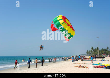 Tourist enjoying parachute ride at colva beach ; Goa ; India Stock Photo