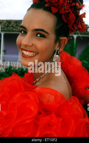 Young girl dressed for the Quinceanera or Quince, the celebration of a girl's fifteenth birthday in Trinidad, Cuba, Caribbean. Stock Photo