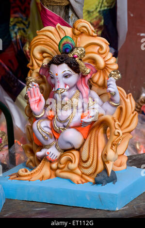 Idol of Lord Ganesh ganpati sitting on throne for sale during Ganesh ...